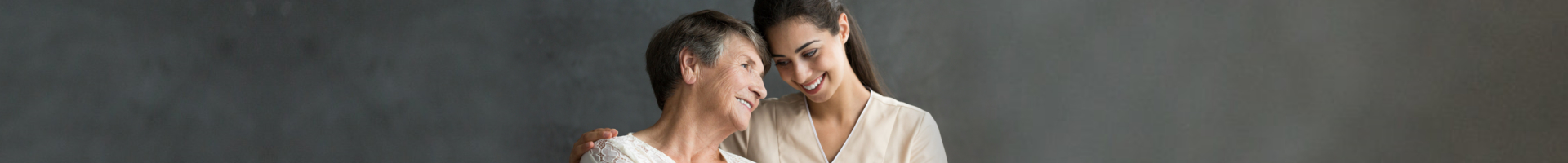 elder woman smiling with female caregiver